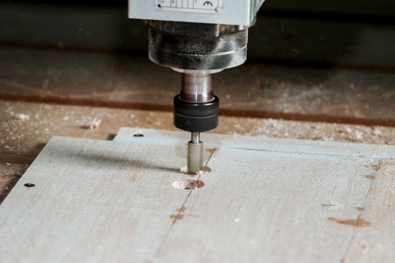 Detailed view of a milling machine cutting wood in a workshop setting.